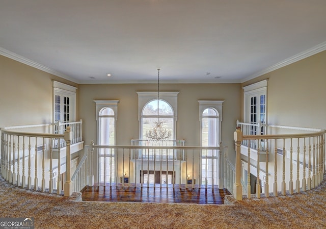 corridor with carpet, ornamental molding, and french doors