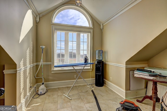 tiled office space featuring ornamental molding and vaulted ceiling