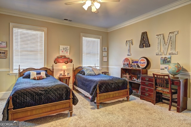 carpeted bedroom featuring ornamental molding and ceiling fan