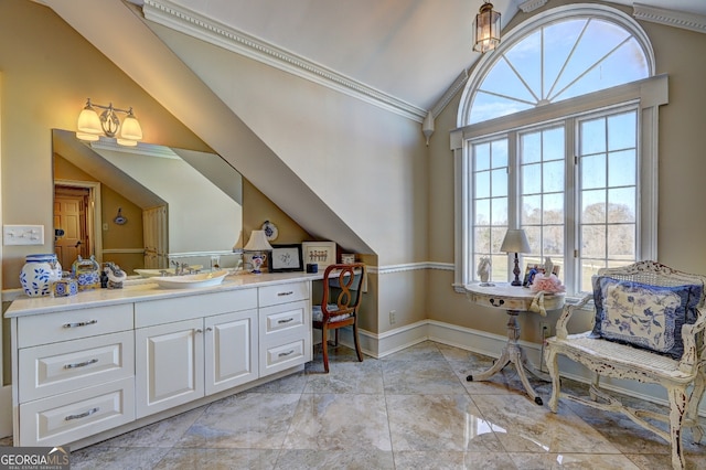 bathroom with crown molding, vaulted ceiling, vanity with extensive cabinet space, and tile flooring