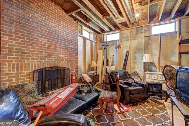 interior space featuring a brick fireplace, brick wall, and a wood stove