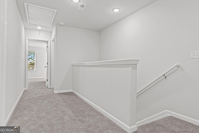 hallway with light colored carpet