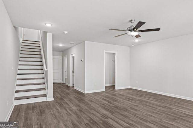 empty room with ceiling fan and dark wood-type flooring