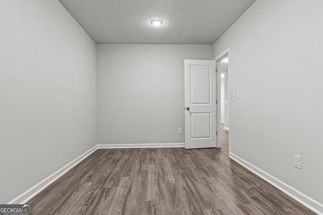 unfurnished room with dark hardwood / wood-style floors