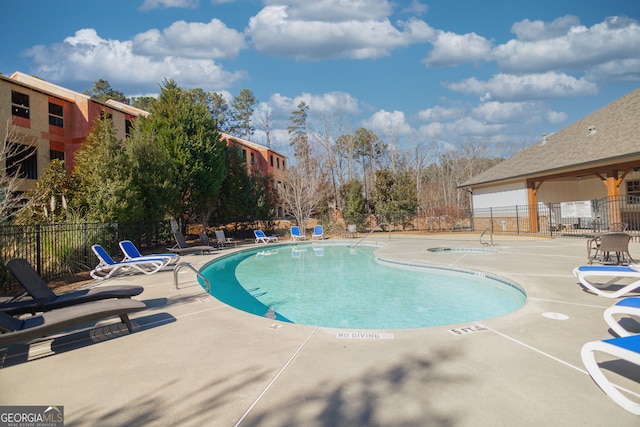 view of swimming pool with a patio area