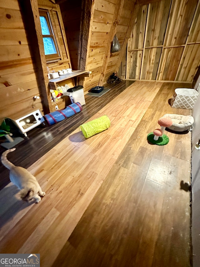 interior space featuring hardwood / wood-style flooring and wooden walls