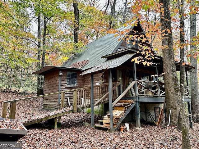 rear view of property featuring a wooden deck