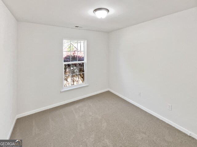 338 Hunterian Pl, Newnan, GA 30265 - spare room featuring baseboards and carpet flooring