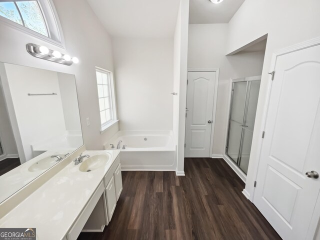 338 Hunterian Pl, Newnan, GA 30265 - bathroom featuring a garden tub, wood finished floors, vanity, and a stall shower