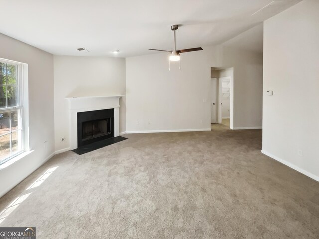 338 Hunterian Pl, Newnan, GA 30265 - unfurnished living room with a fireplace with flush hearth, baseboards, and carpet