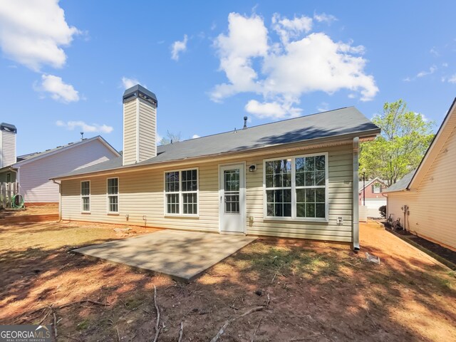 338 Hunterian Pl, Newnan, GA 30265 - back of house featuring a chimney and a patio