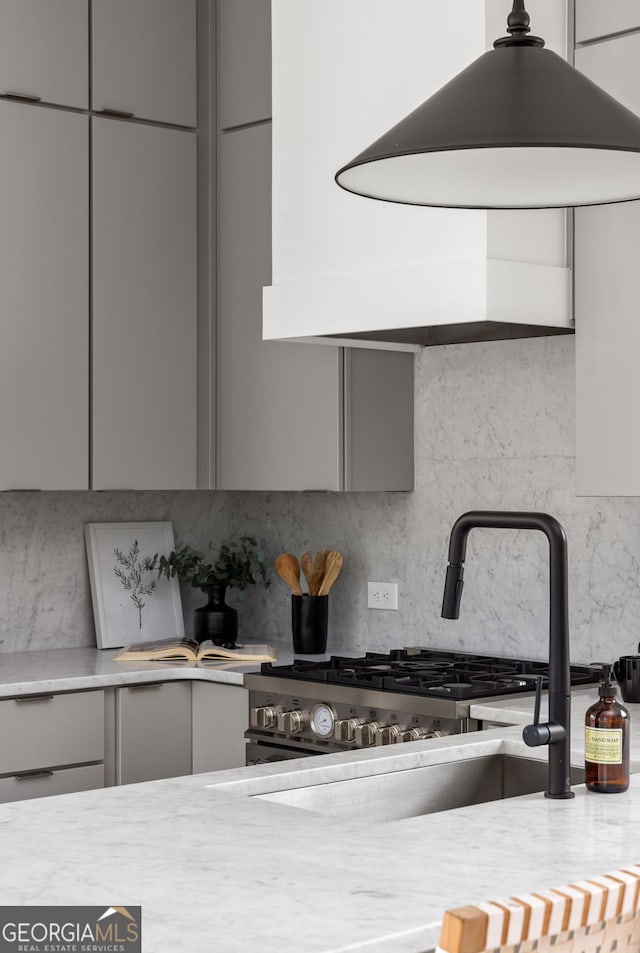 details with gray cabinets, tasteful backsplash, and sink