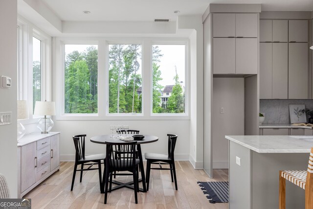 dining space with light wood-type flooring and a wealth of natural light