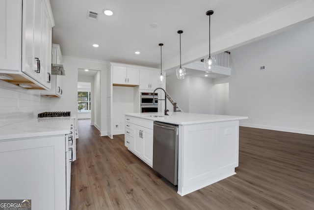 kitchen featuring hardwood / wood-style flooring, sink, a kitchen island with sink, white cabinetry, and appliances with stainless steel finishes