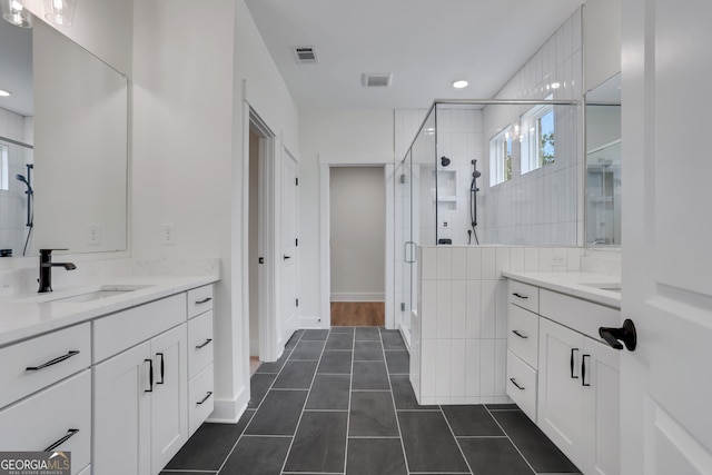 bathroom featuring vanity, tile patterned flooring, and a shower with door