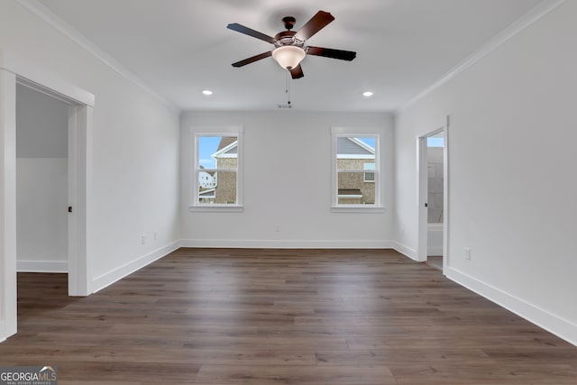 spare room with dark hardwood / wood-style flooring, ornamental molding, and ceiling fan