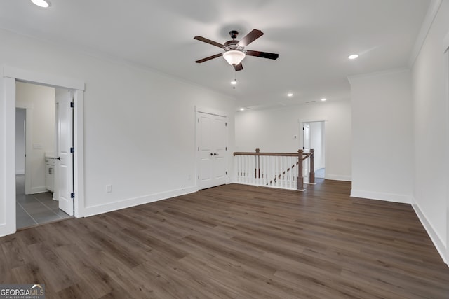 spare room featuring ceiling fan, dark hardwood / wood-style floors, and crown molding