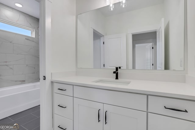 bathroom featuring tiled shower / bath combo, vanity, and tile patterned floors