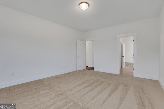 unfurnished bedroom featuring light carpet