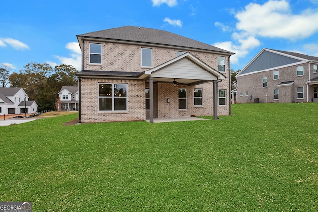 back of property featuring ceiling fan, a yard, and a patio area