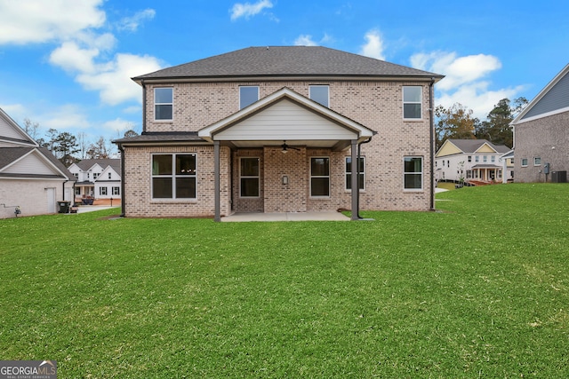 back of property featuring a patio area, a yard, and ceiling fan