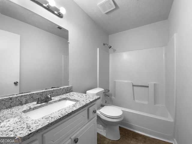 full bath featuring a textured ceiling, toilet, shower / bath combination, vanity, and visible vents