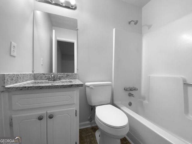 bathroom with shower / bath combination, vanity, toilet, and baseboards