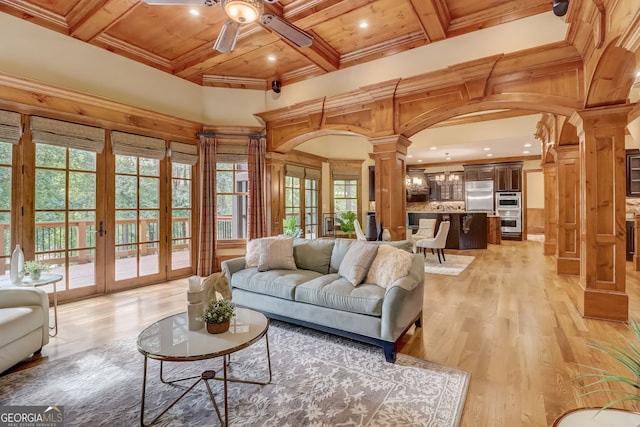 living room featuring ornate columns, french doors, light hardwood / wood-style flooring, ceiling fan, and wood ceiling