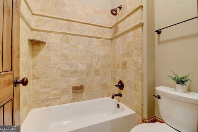 bathroom featuring tiled shower / bath combo and toilet