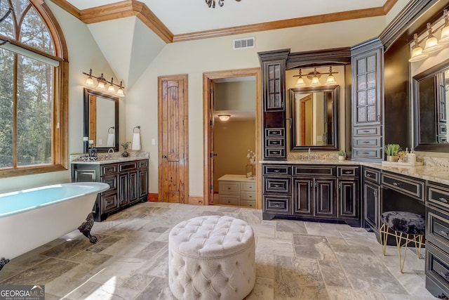 bathroom with a bath, plenty of natural light, tile flooring, and vanity with extensive cabinet space