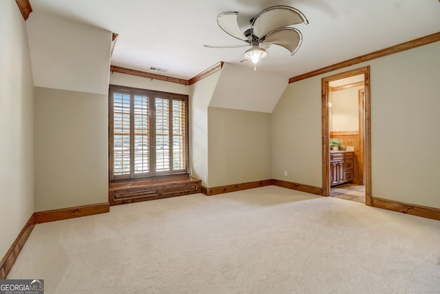 interior space with ceiling fan, light colored carpet, and vaulted ceiling