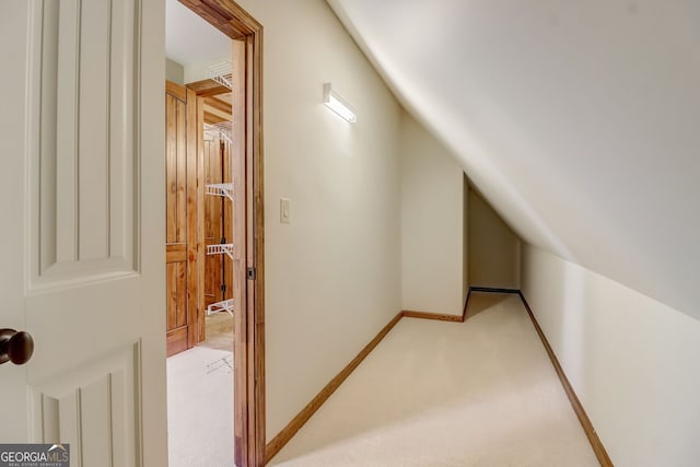 additional living space with light colored carpet and vaulted ceiling