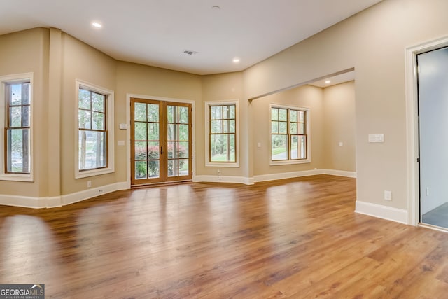 empty room with french doors and light wood-type flooring