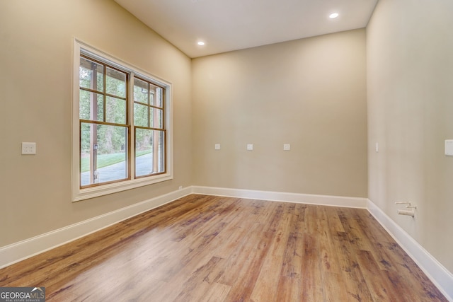 unfurnished room featuring a healthy amount of sunlight and light wood-type flooring