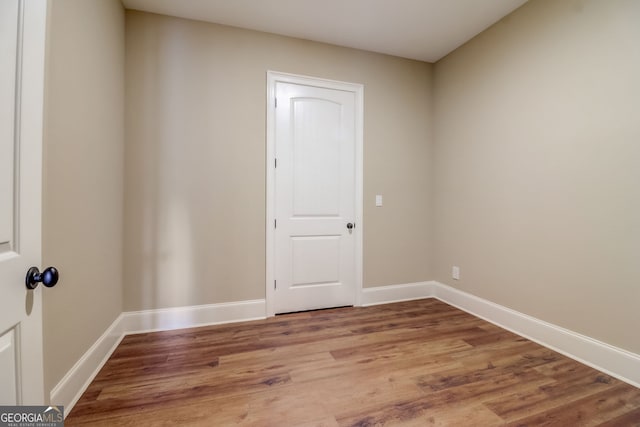 spare room featuring dark hardwood / wood-style flooring