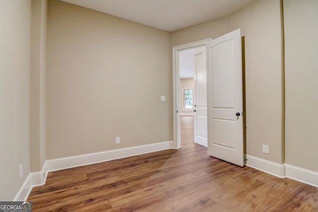 empty room featuring dark hardwood / wood-style flooring