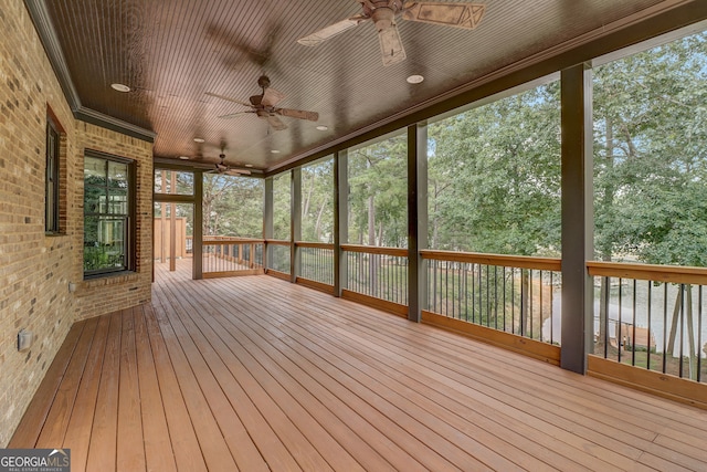 unfurnished sunroom with wooden ceiling and ceiling fan