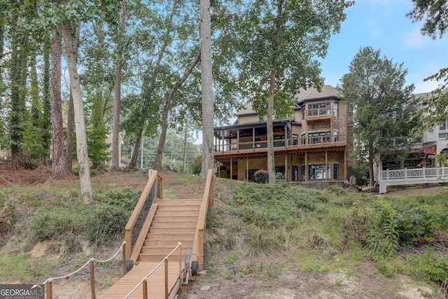 back of house featuring a wooden deck