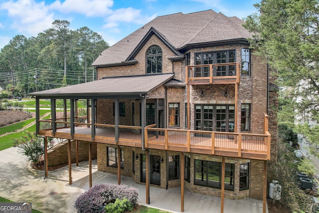 rear view of house with central AC unit and a patio area