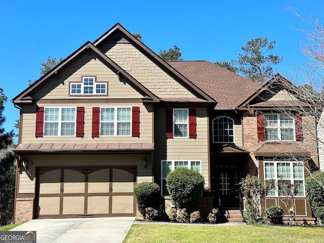 craftsman house with a front lawn and a garage