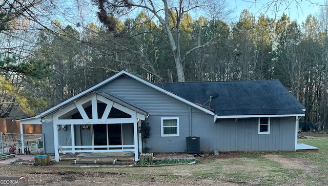 rear view of house with central AC unit