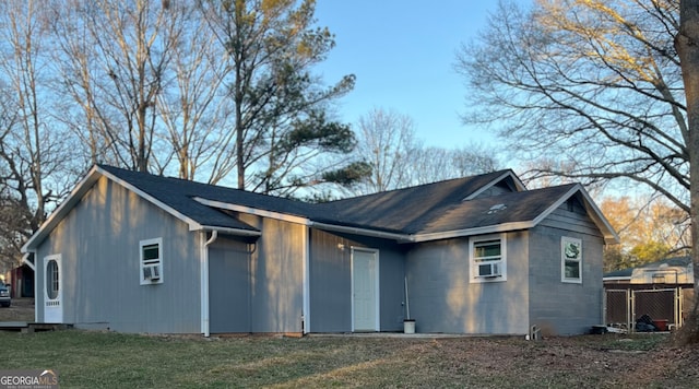 rear view of house featuring a yard