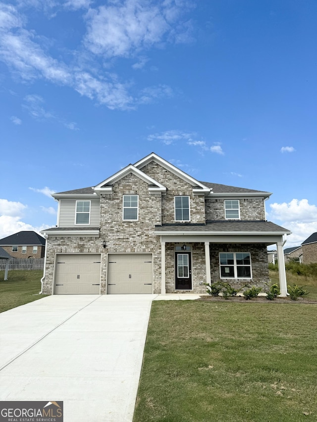 view of front of home featuring a front lawn and a garage