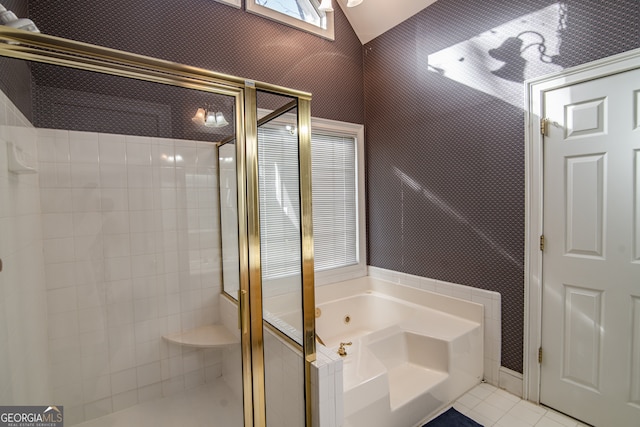 bathroom with a shower with door and tile flooring