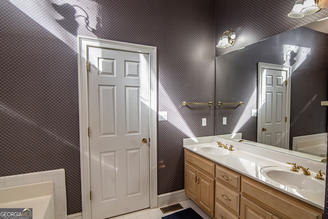 bathroom featuring double sink vanity, tile flooring, and a tub