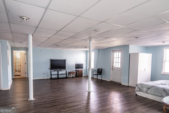 interior space with dark hardwood / wood-style floors and a drop ceiling