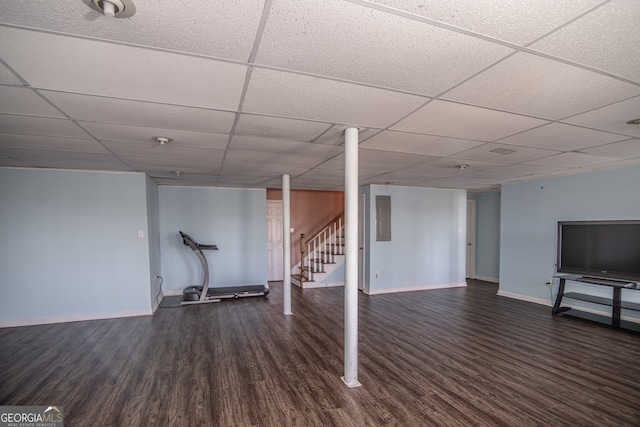 basement featuring dark hardwood / wood-style flooring and a paneled ceiling