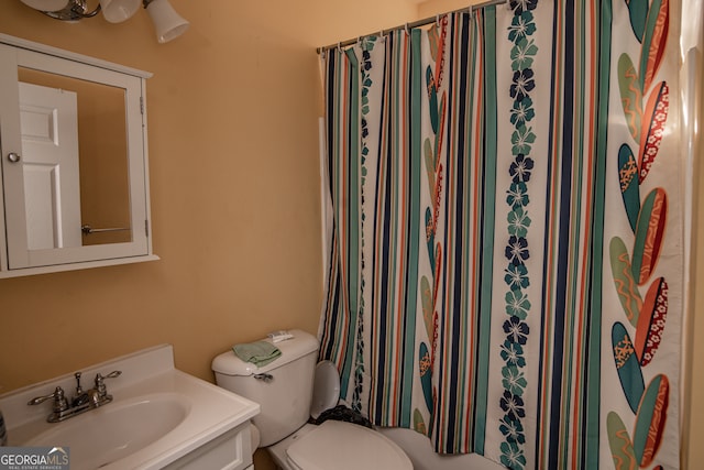 bathroom featuring oversized vanity and toilet