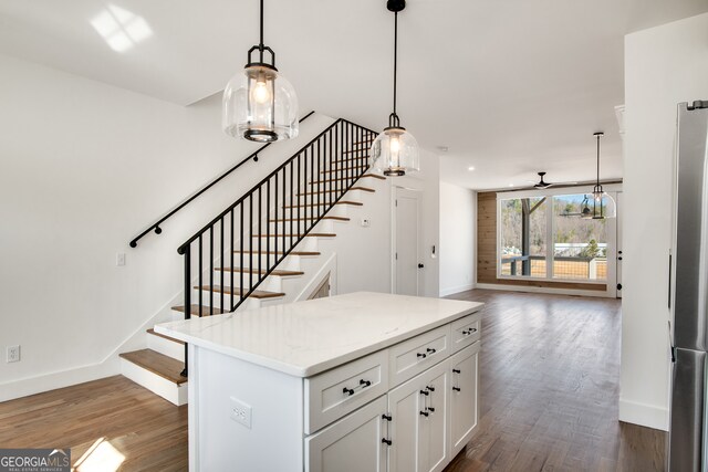 stairway featuring ceiling fan and dark hardwood / wood-style floors