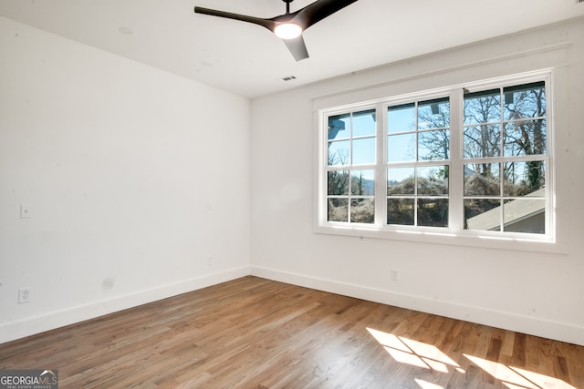 empty room with ceiling fan and light wood-type flooring